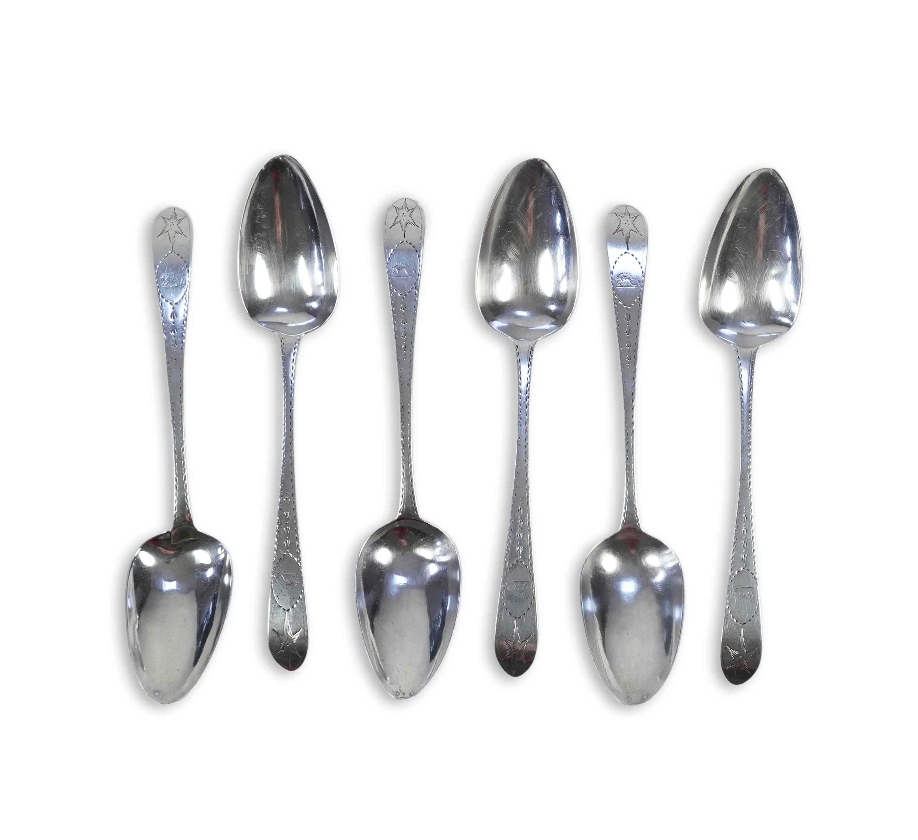 A set of six George III Irish silver bright cut engraved serving/table spoons by John Pittar